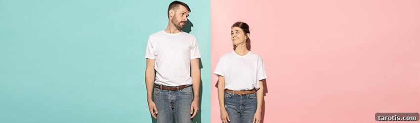 Twin Flame Guide: Signs, Stages, and Reunion Insights 2 A man and a woman, both wearing white shirts, brown belts, and jeans, stand facing forward and look at each other sideways.