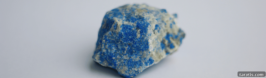 10 Healing Crystals to Help You Recover from a Breakup 3 A raw chunk of Lapis Lazuli on a grey background.