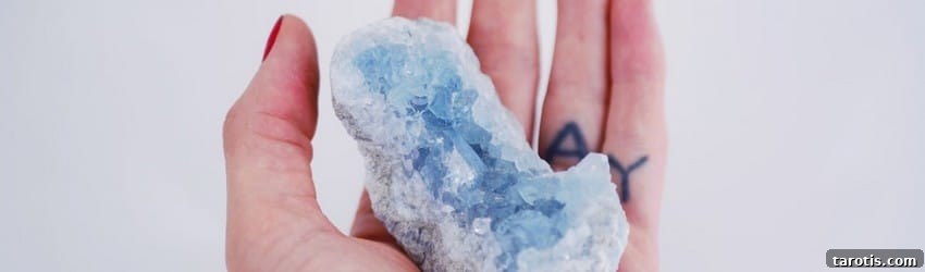 5 Ways to Embrace Renewal This Winter Solstice 3 hand-holding-a-blue-crystal