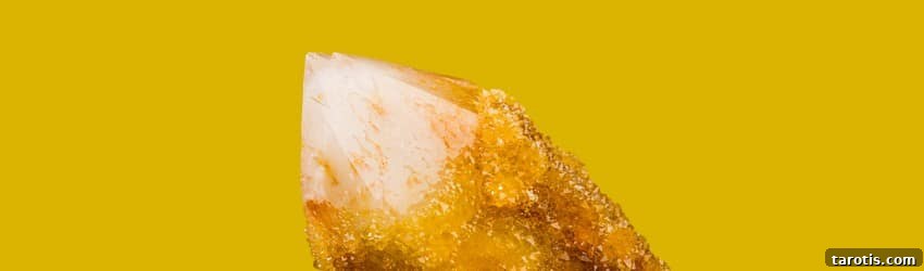Top Crystals to Embrace Autumn Energy 4 A yellow citrine crystal shard pointing towards the top left of the image on an orange background.