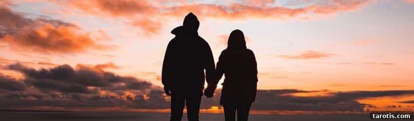 How to Seduce Each Zodiac Sign: Turn-Ons and Attraction Tips 3 A silhouetted couple holds hands while watching the orange and purple sunset.