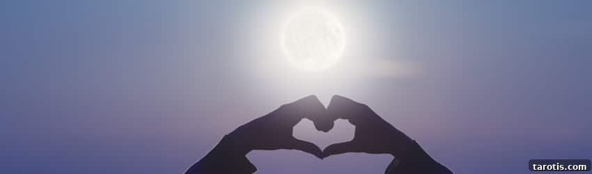 Moon Phases and Relationship Compatibility: What Your Sign Reveals 2 A woman holds her hands up in front of the Full Moon in a heart shape.