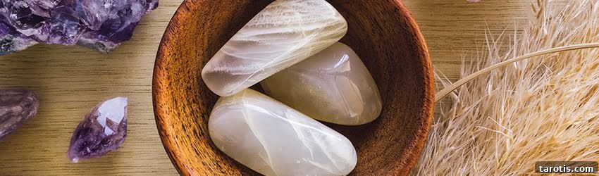 Moonstone Meaning, Properties, and How to Use Its Lunar Energy 2 Moonstone in a bowl surrounded by Amethyst crystals.